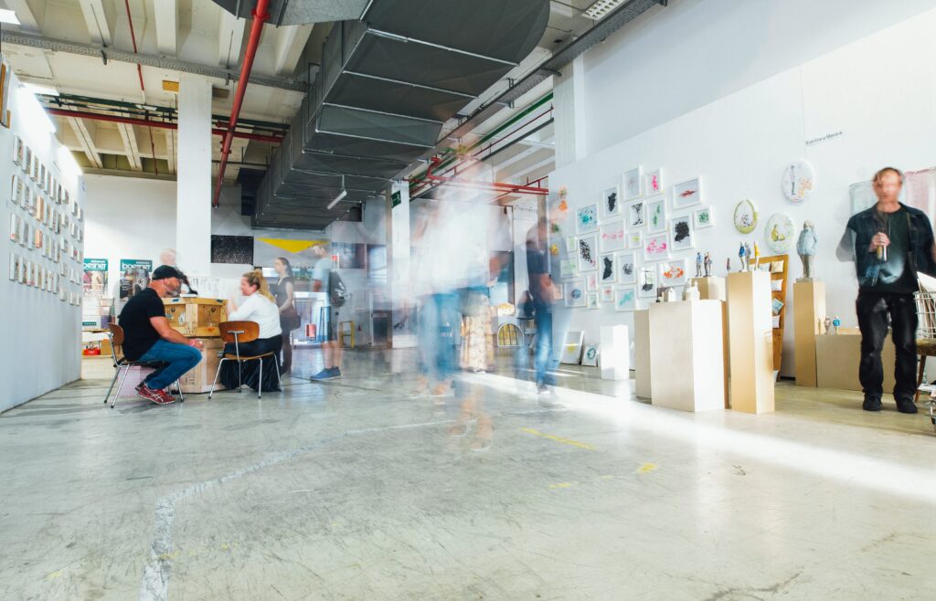 A photograph of an art exhibition in a bright gallery space