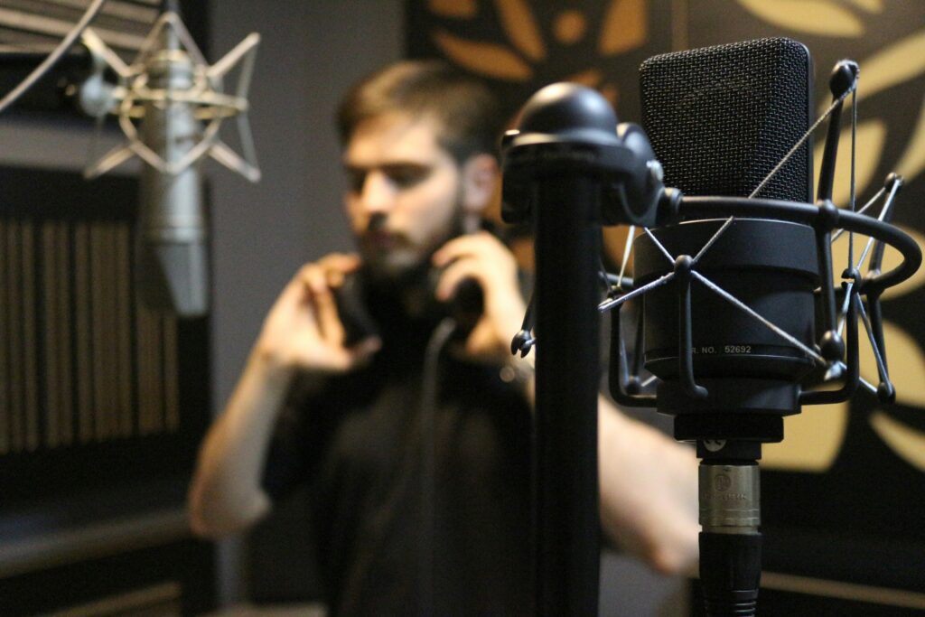 Photograph of a man in a music recording suite