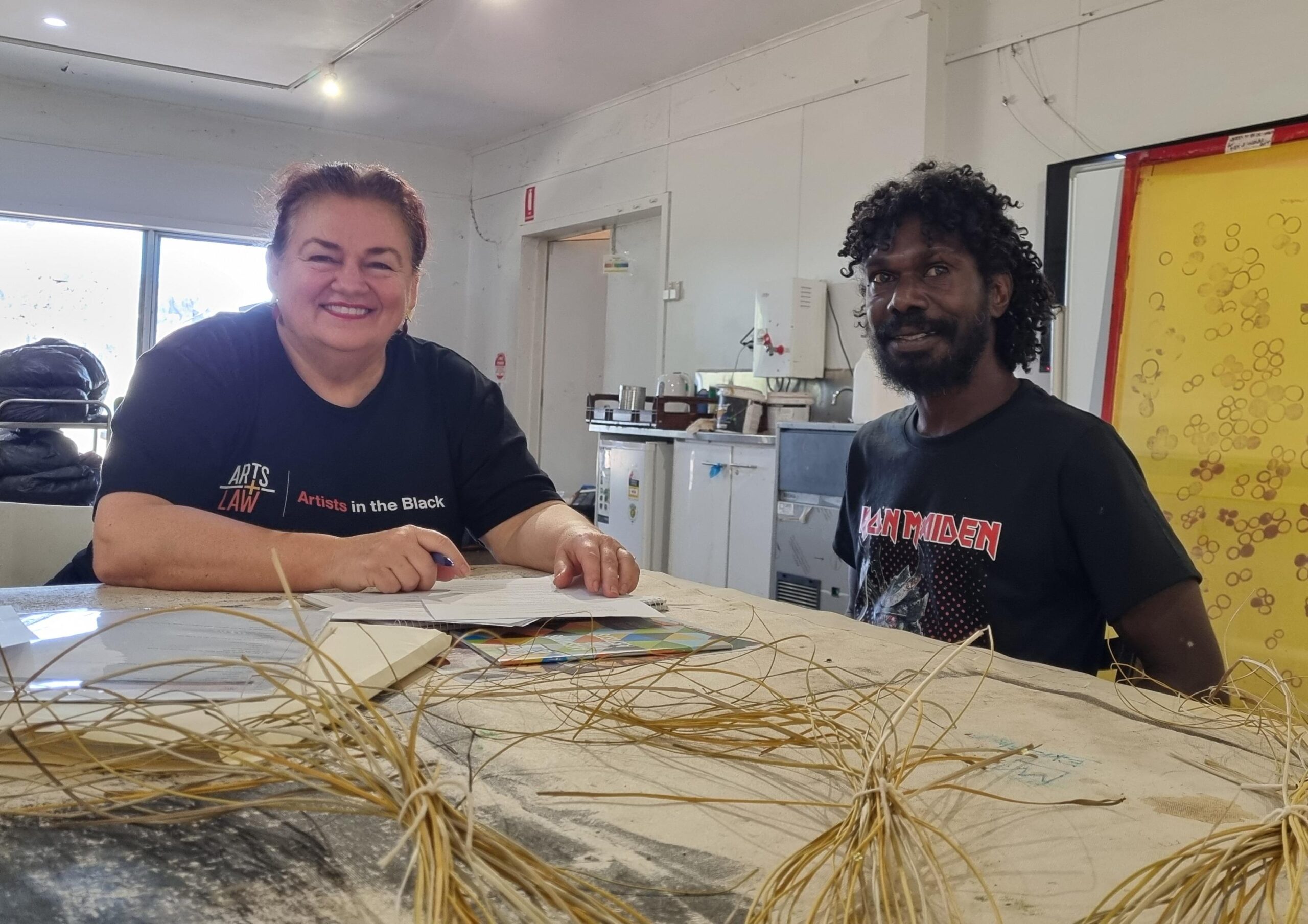 Donna Robinson sitting with an artist from Injalak