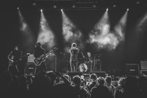 Black and white image of a band in front of a large crowd.